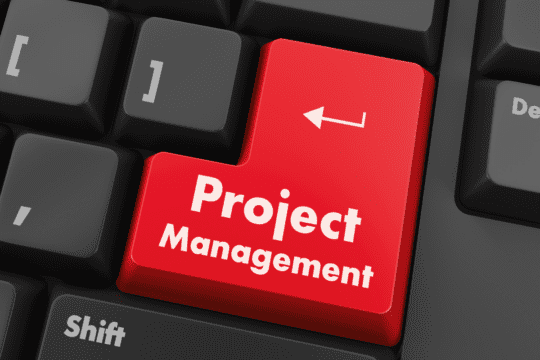 computer "enter" key with the words "project management" written on it.